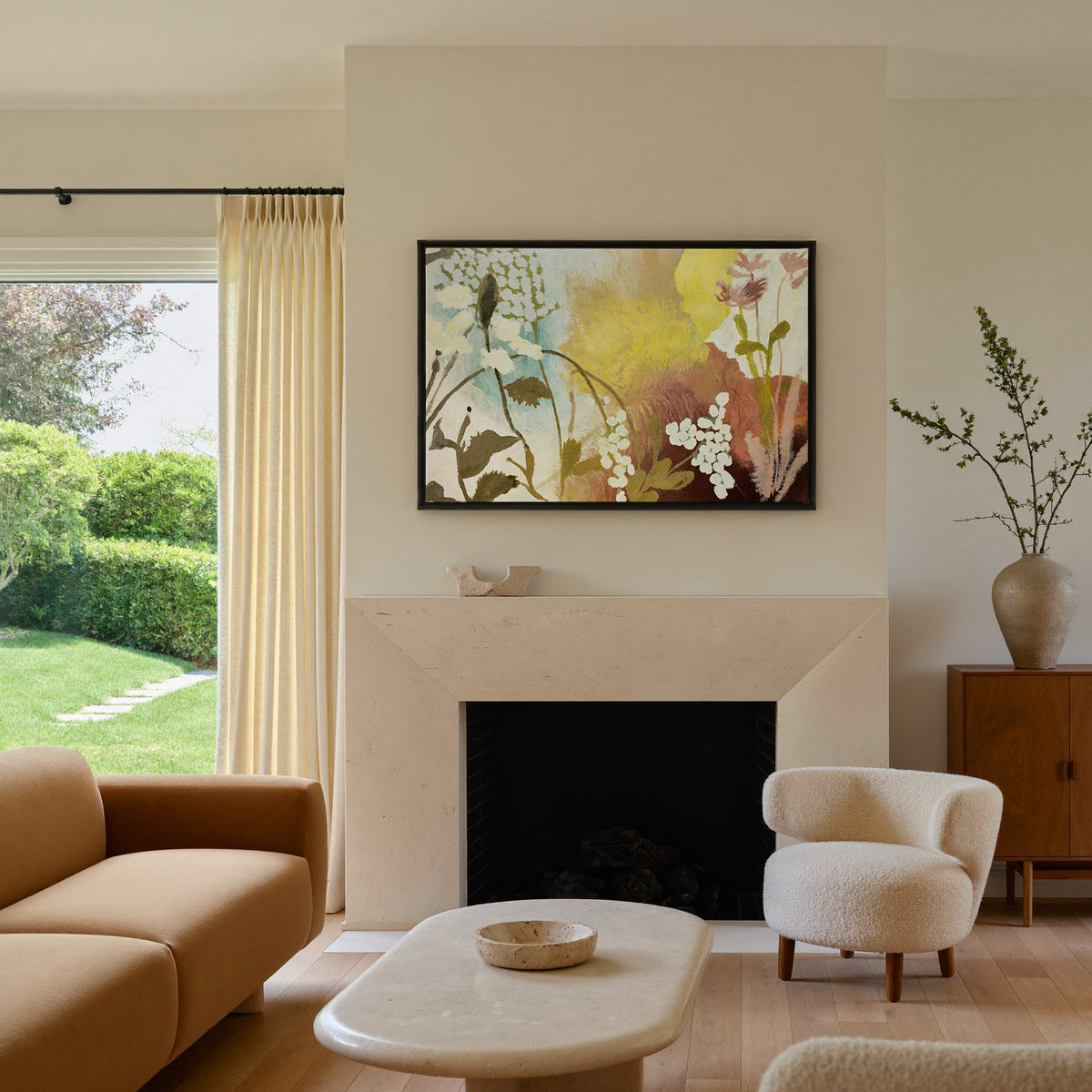 soft wildflower abstract with yellow, blush, canvas wall art in a black frame above a mantel