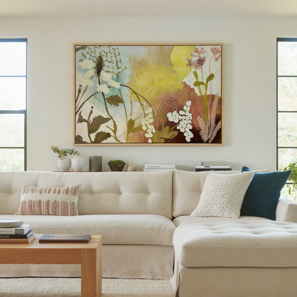soft wildflower abstract with yellow, blush, canvas wall art in a natural wood frame in a living room