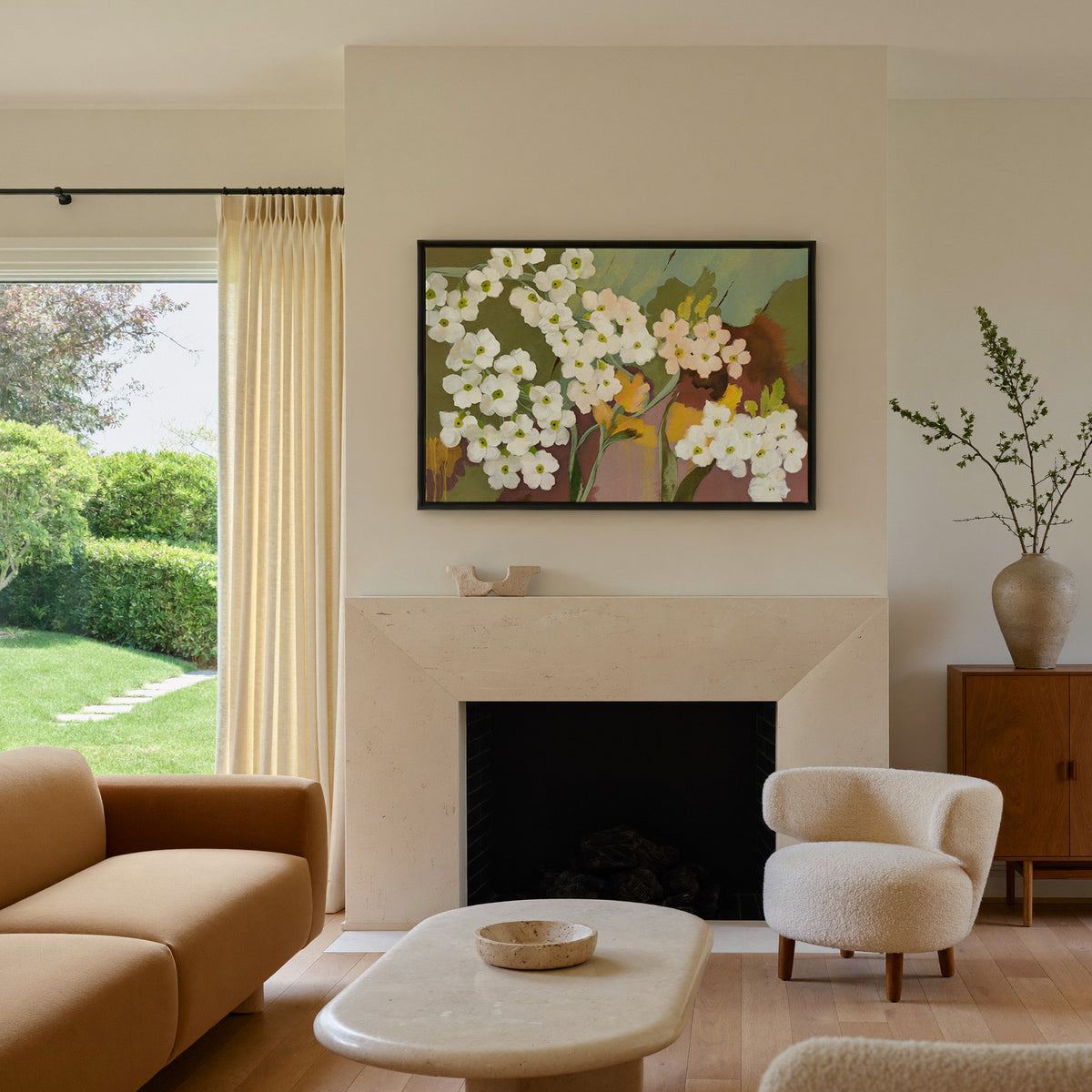 white and blush floral abstract with olive canvas wall art in a black frame above a mantel
