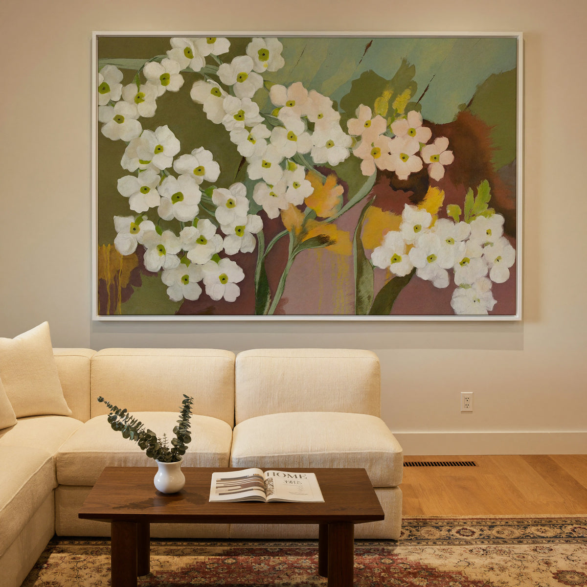 white and blush floral abstract with olive canvas wall art in a white frame in a styled room setting