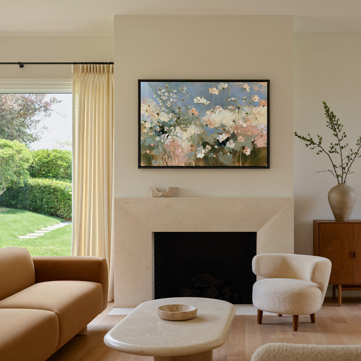 soft white and blush wildflowers under a blue canvas wall art in a black frame above a mantel