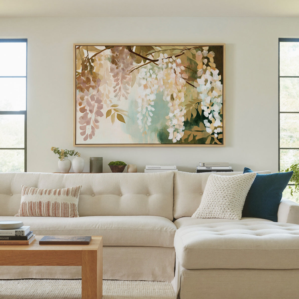 soft hanging wisteria in cream, blush, and sage canvas wall art in a natural wood frame in a living room