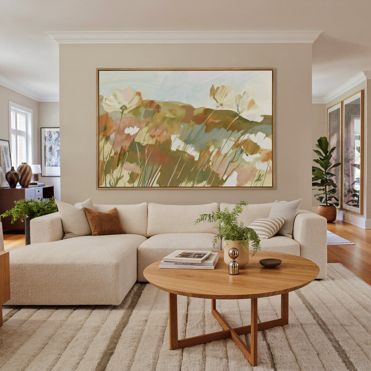 soft apricot poppies in a loose meadow canvas wall art in an oak frame in a living room