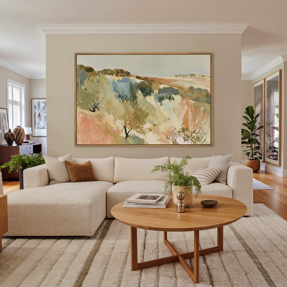 warm hillside olive orchard with pale sky and canvas wall art in an oak frame in a living room