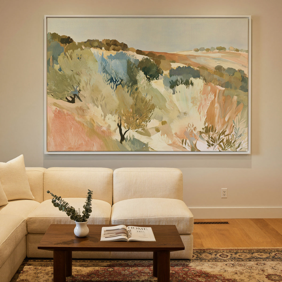 warm hillside olive orchard with pale sky and canvas wall art in a white frame in a styled room setting