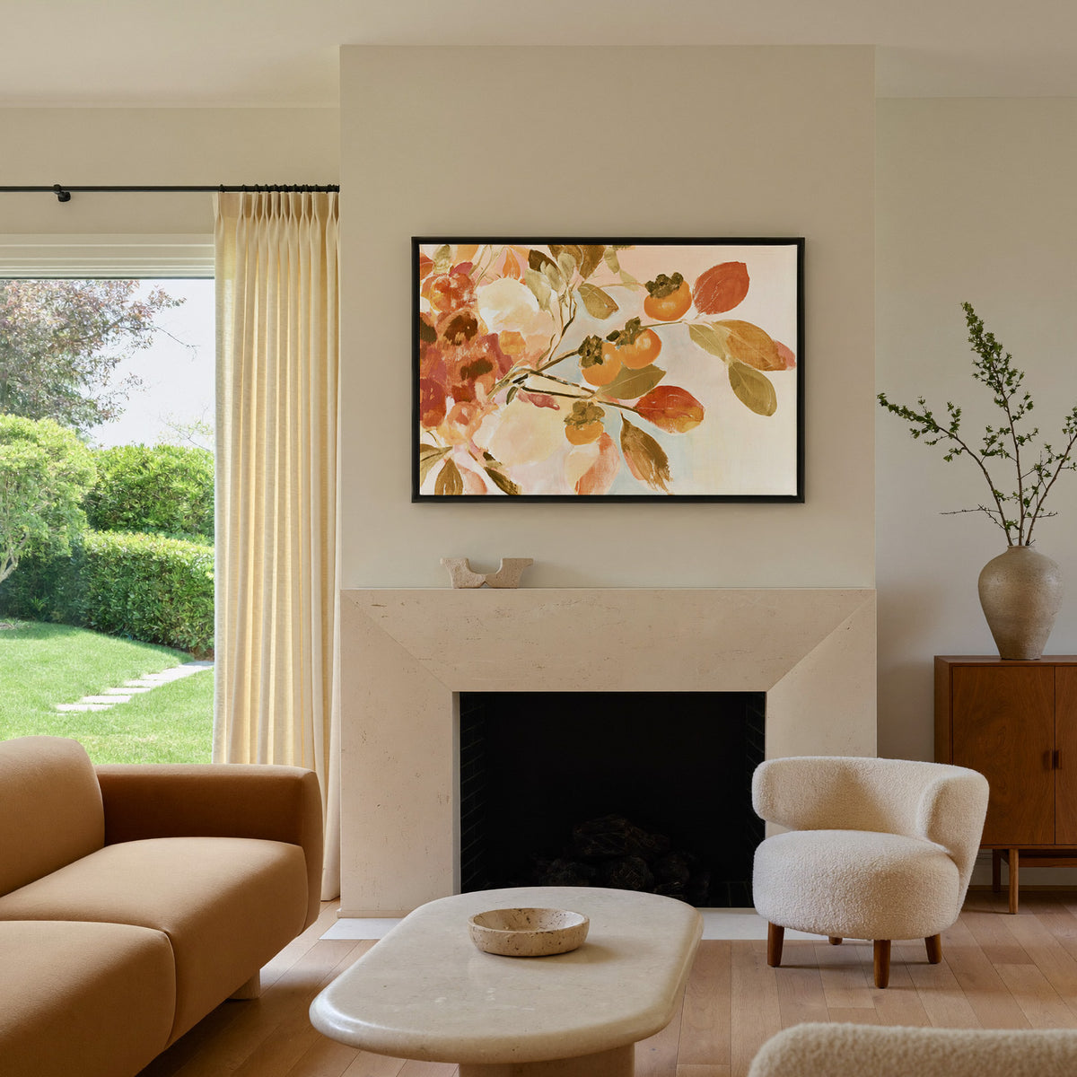 late autumn persimmon branches with orange canvas wall art in a black frame above a mantel