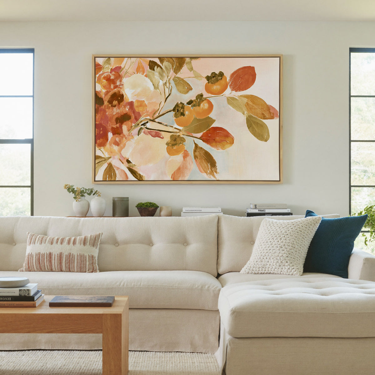 late autumn persimmon branches with orange canvas wall art in a natural wood frame in a living room