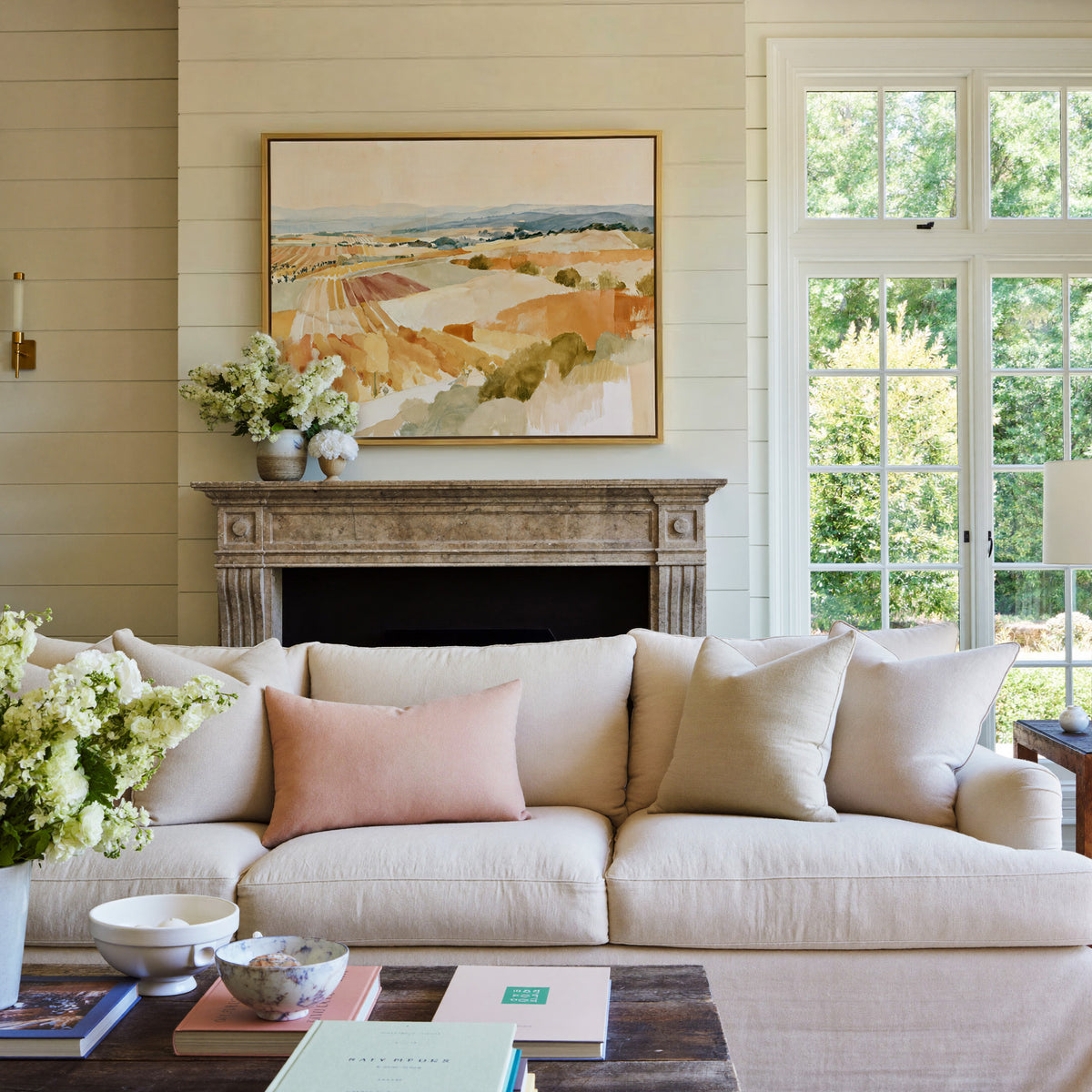 soft vineyard hills in ochre, cream, and blue canvas wall art in a gold frame above a mantel
