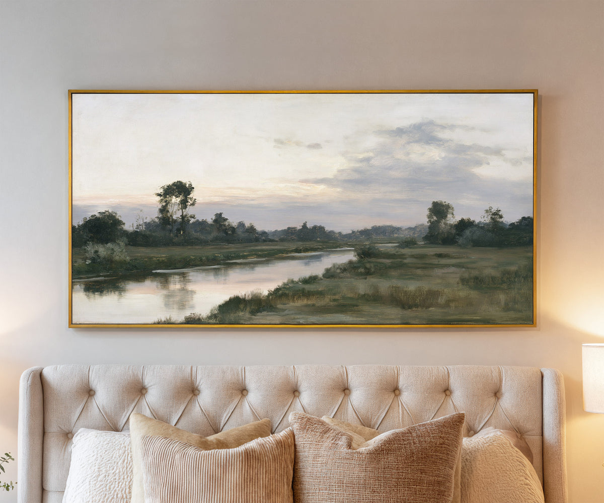 quiet river meadow at first light canvas wall art in a gold frame above a bed