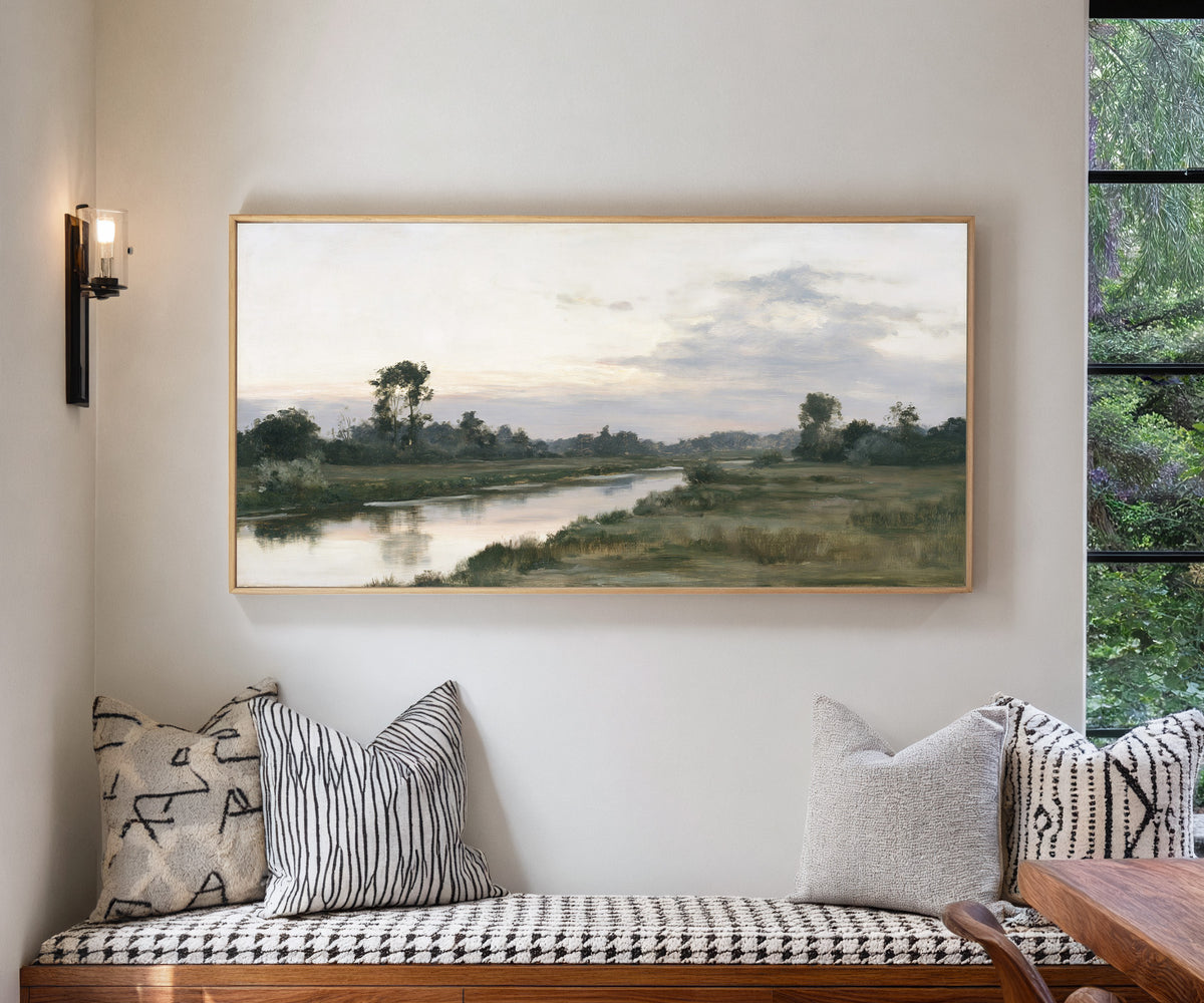 quiet river meadow at first light canvas wall art in a natural wood frame in a living room