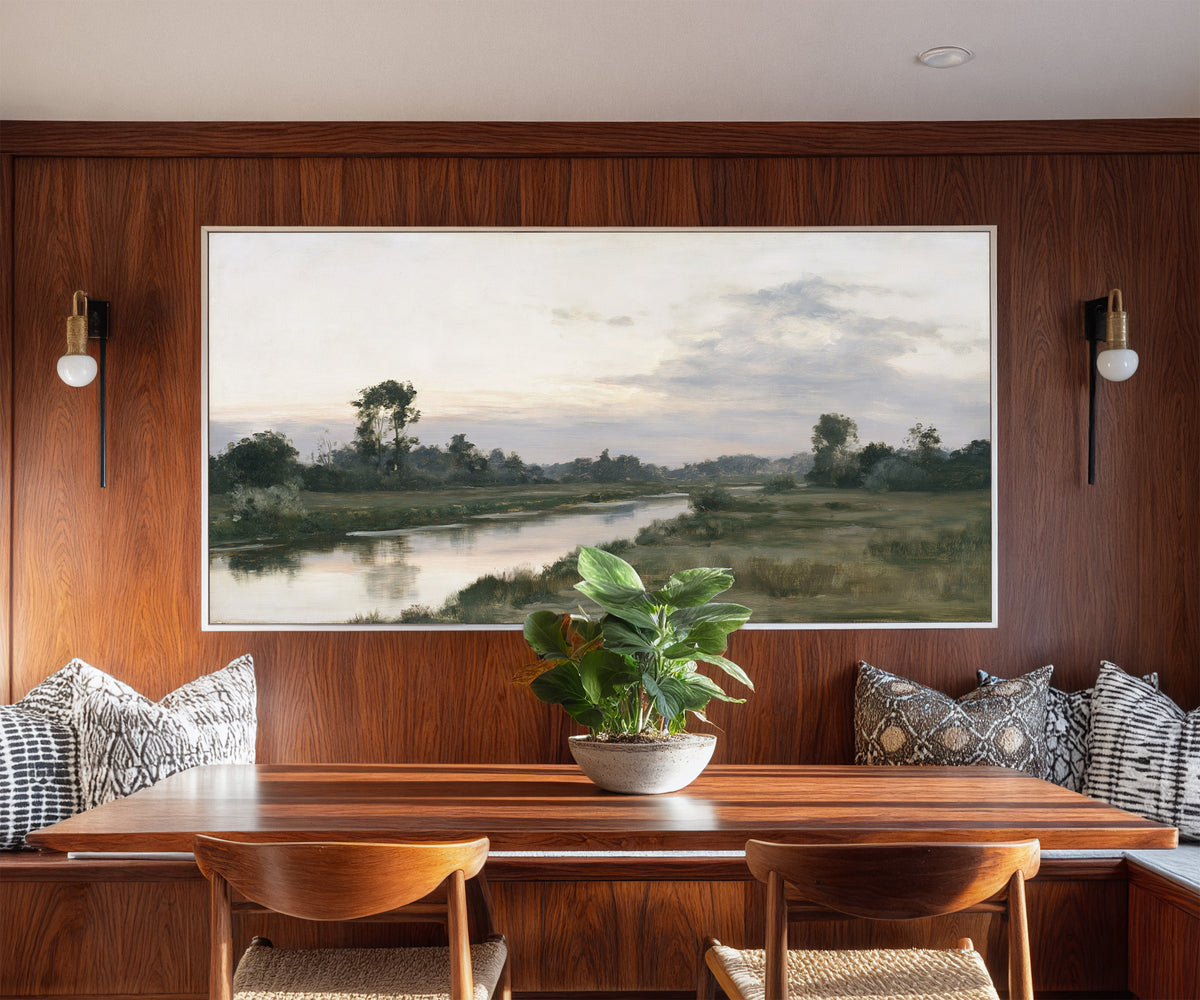 quiet river meadow at first light canvas wall art in a white frame in a styled room setting