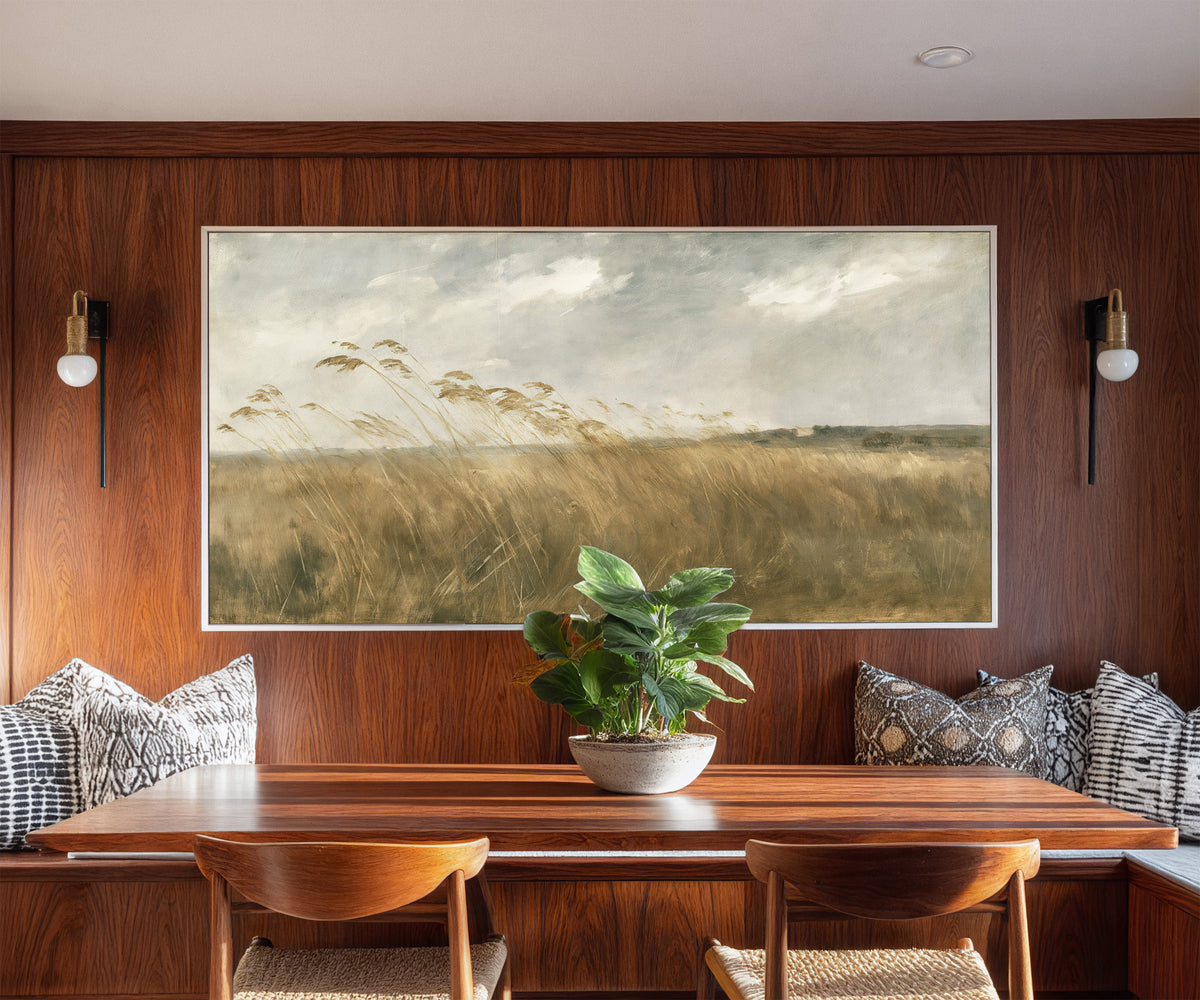 wide field of tall grasses bending in one canvas wall art in a white frame in a styled room setting