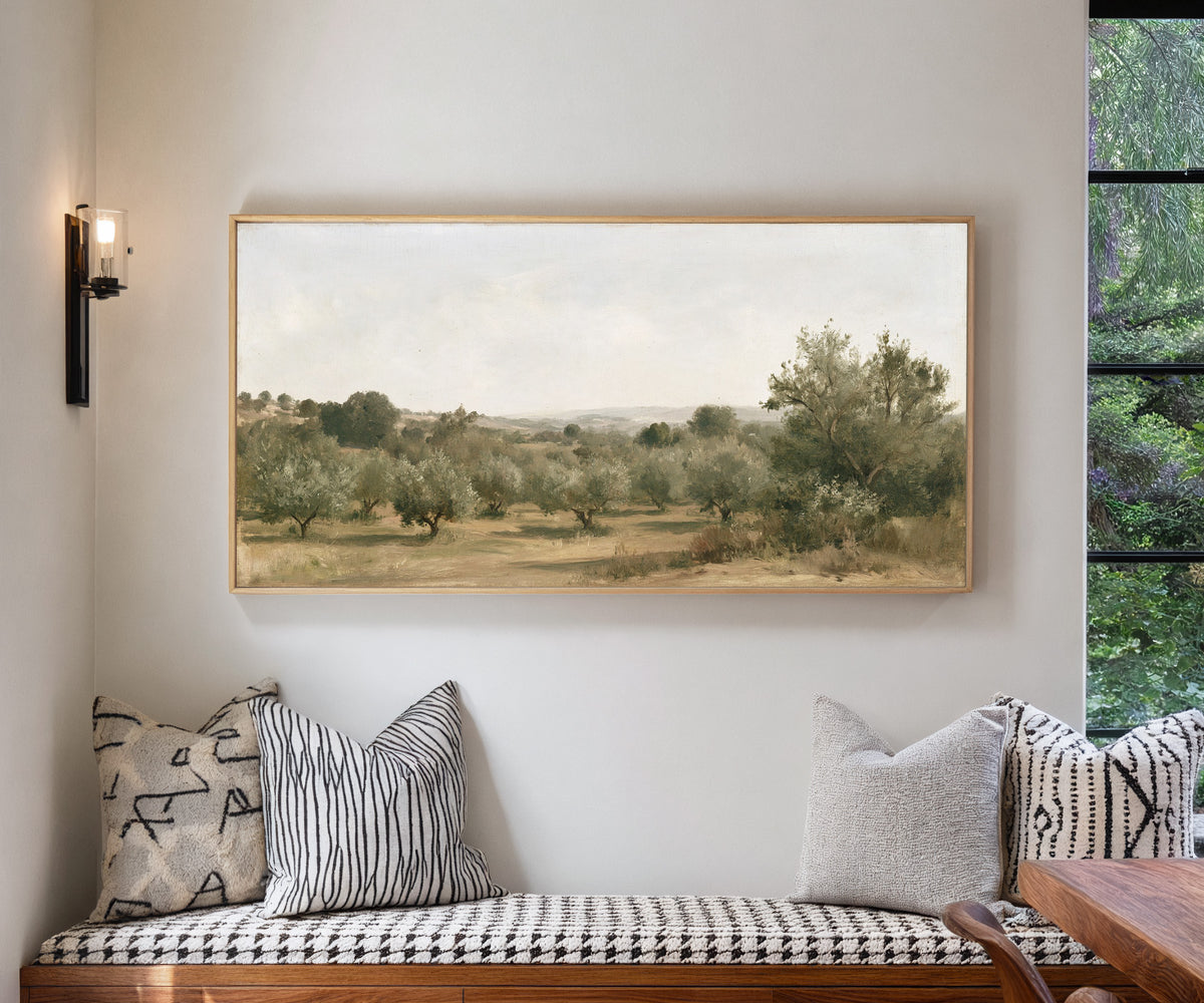 late summer orchard with uneven rows of small canvas wall art in a natural wood frame in a living room