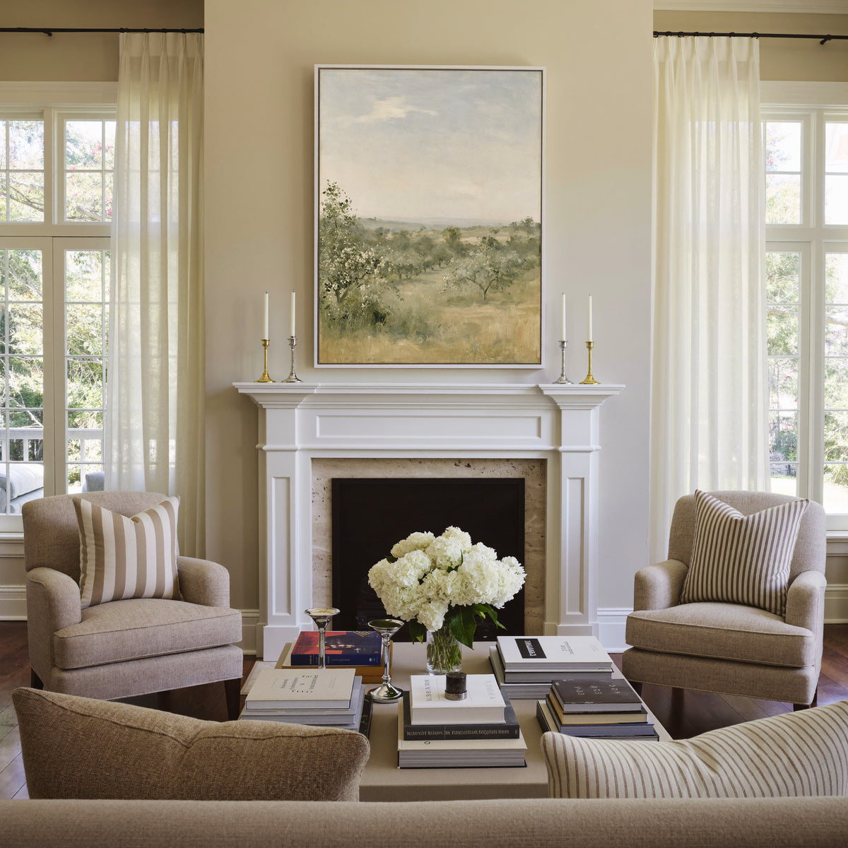 late summer orchard with uneven rows of small canvas wall art in a white frame above a mantel