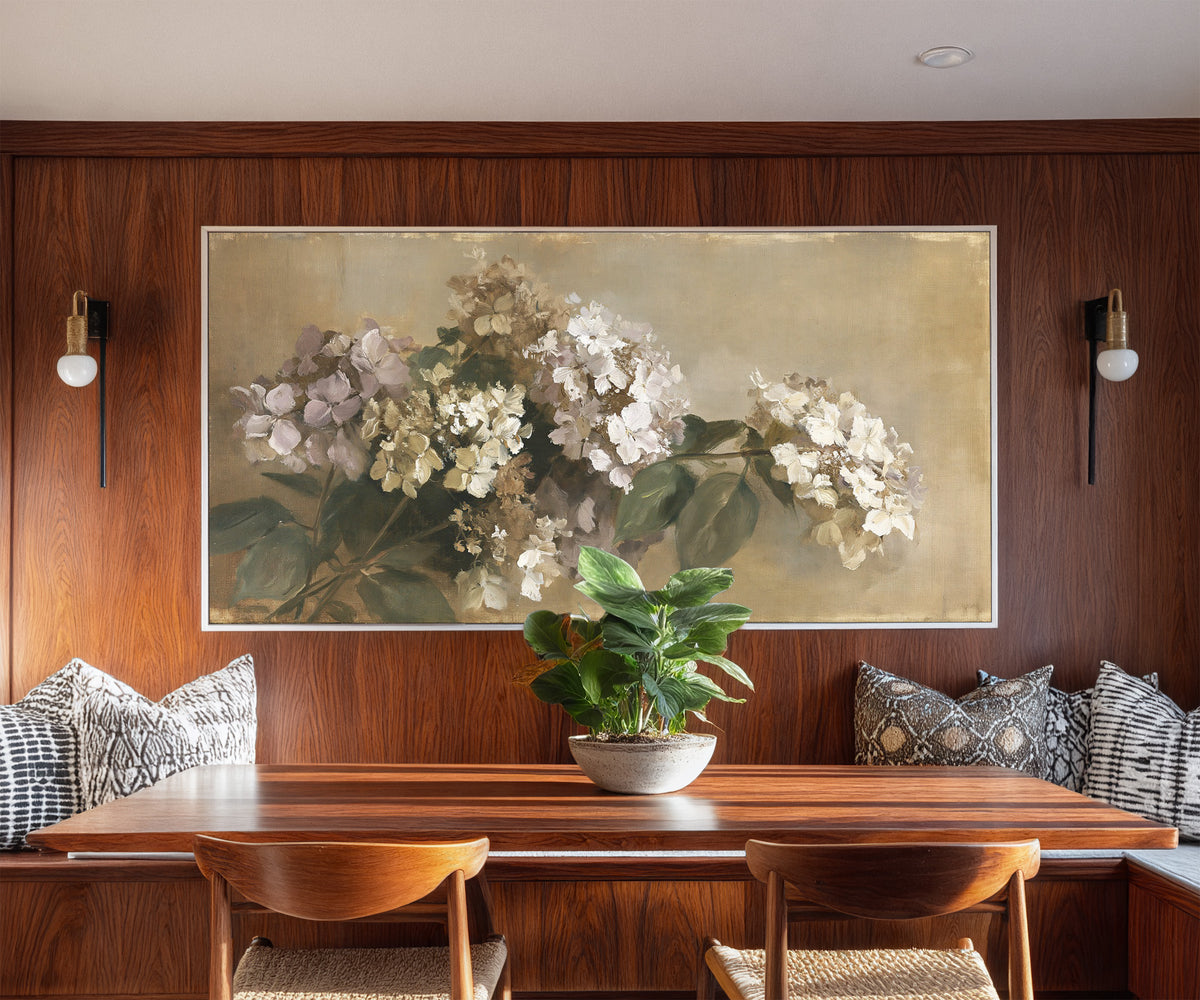 faded hydrangea cluster in cream, mauve, and canvas wall art in a white frame in a styled room setting