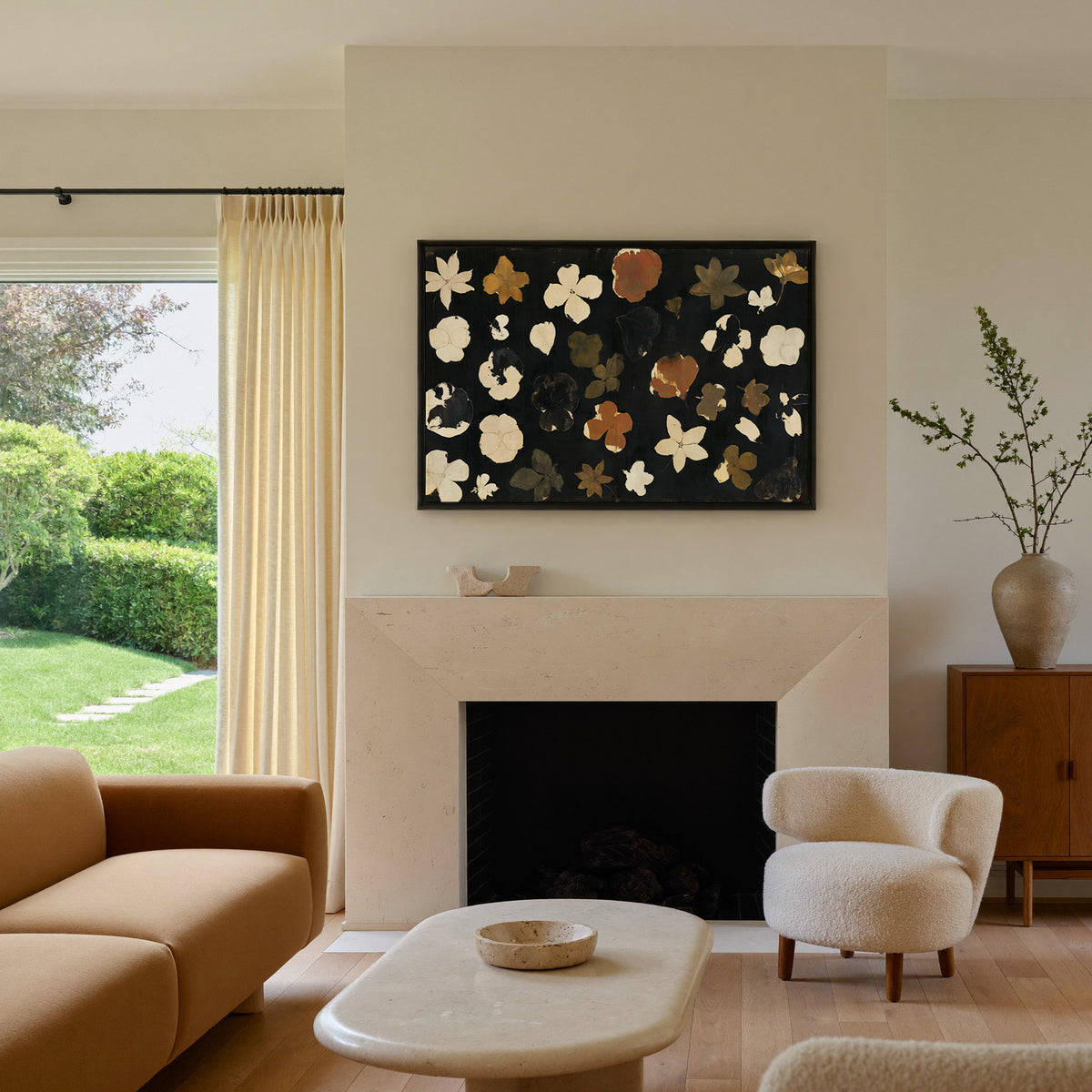 wild meadow flowers on a dark ground canvas wall art in a black frame above a mantel