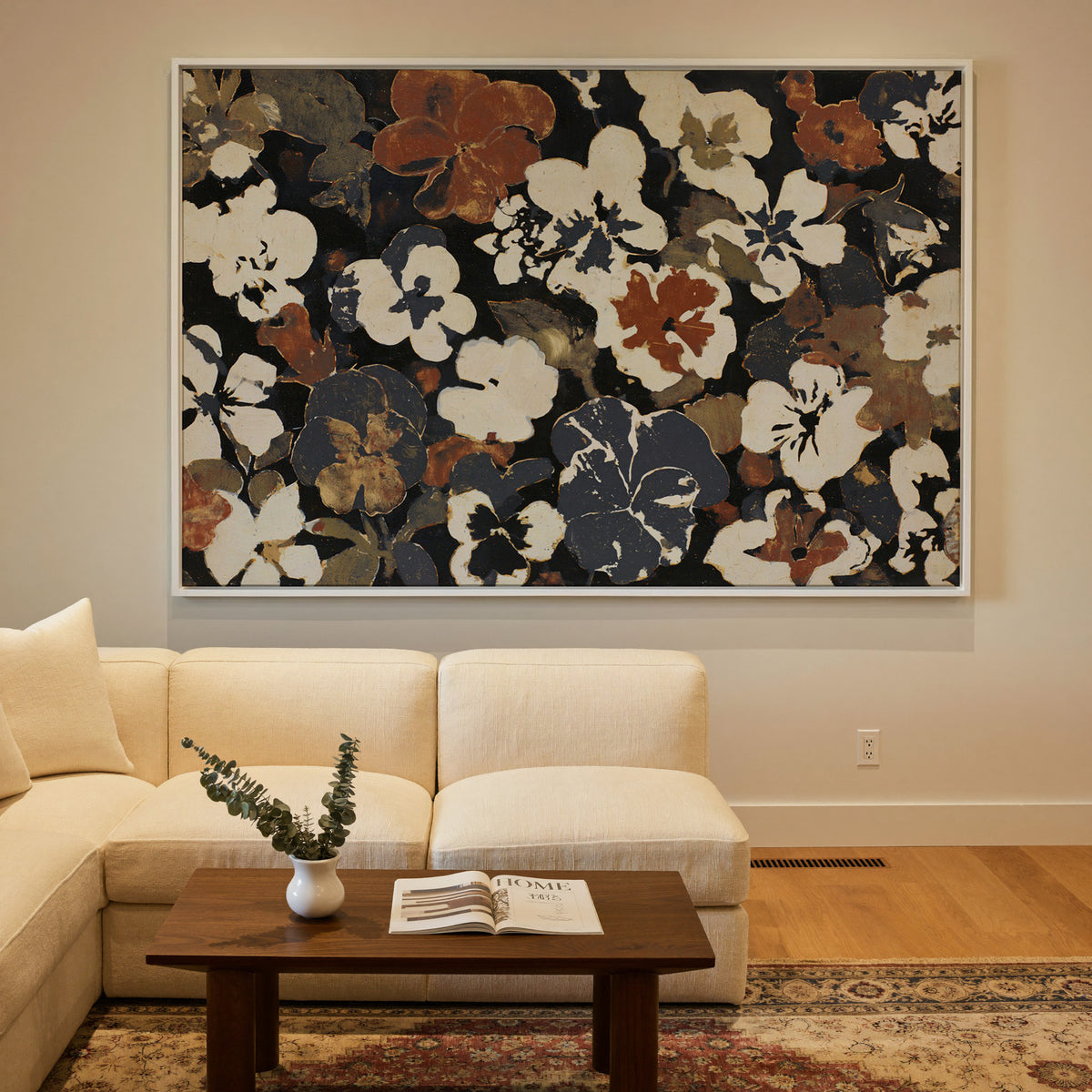 dark meadow flowers in cream, rust, and charcoal canvas wall art in a white frame in a styled room setting