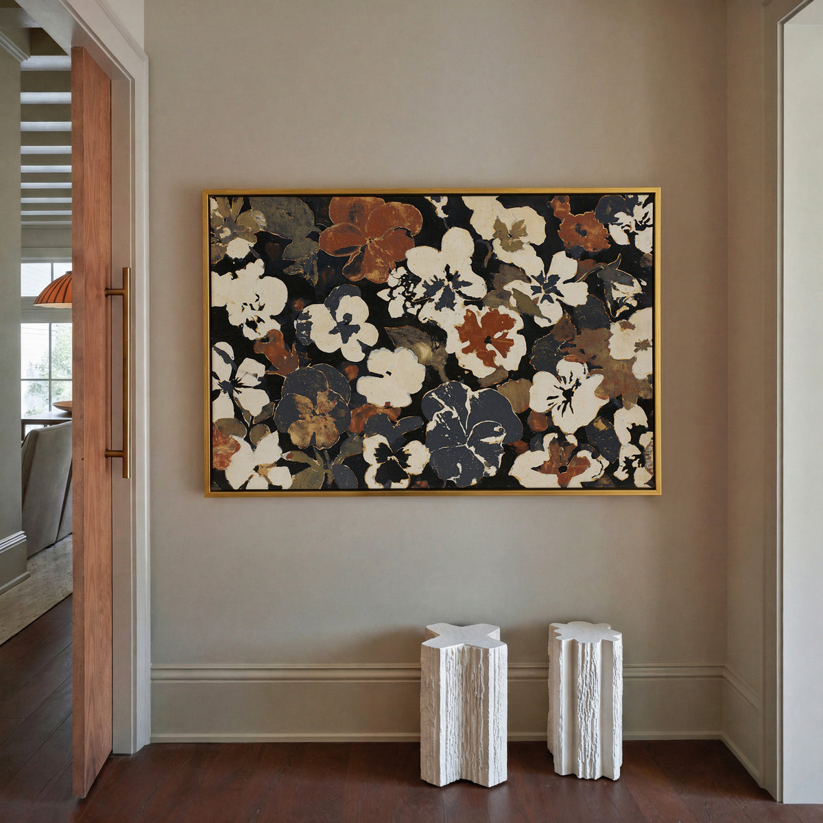 dark meadow flowers in cream, rust, and charcoal canvas wall art in a gold frame in a styled room setting