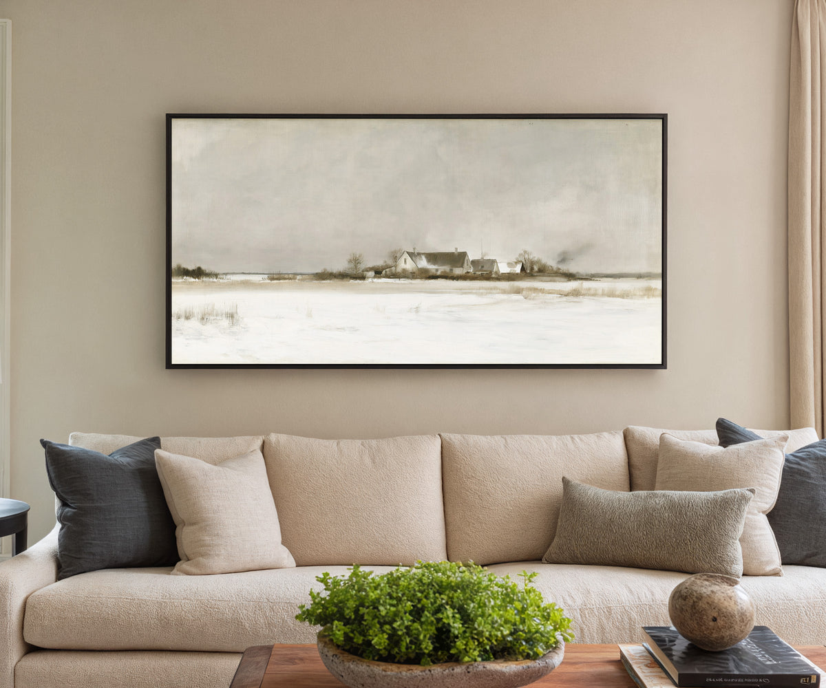 pale winter farmhouse landscape canvas wall art in a black frame in a styled room setting