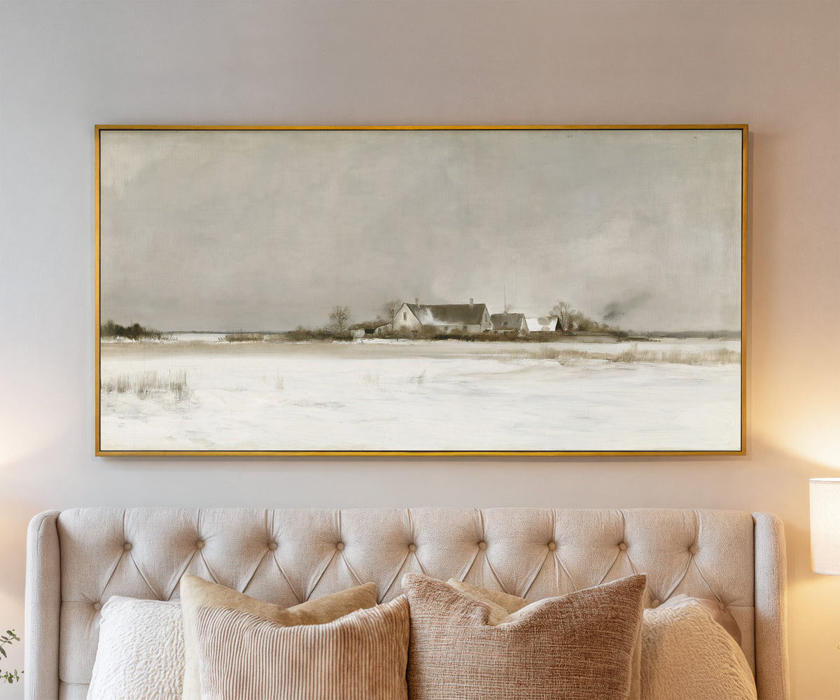 pale winter farmhouse landscape canvas wall art in a gold frame above a bed