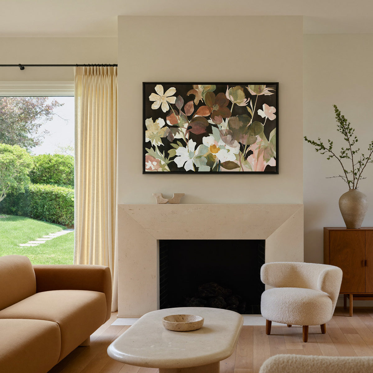 wild meadow flowers on a dark ground canvas wall art in a black frame above a mantel