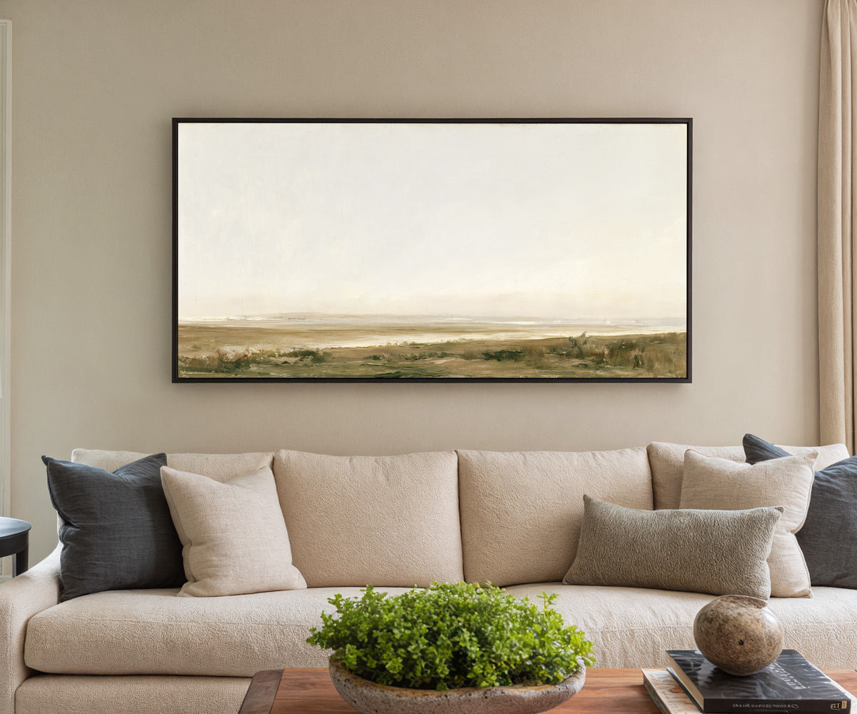 pale coastal landscape with low marshy ground canvas wall art in a black frame in a styled room setting