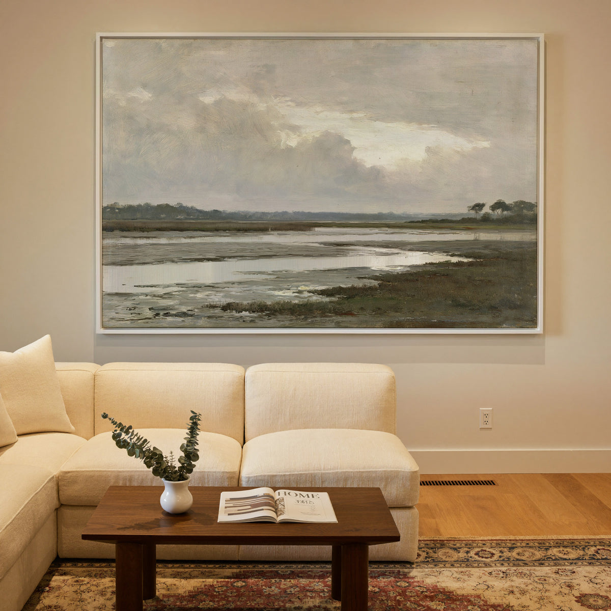 quiet inlet with mudflats and distant reed beds canvas wall art in a white frame in a styled room setting