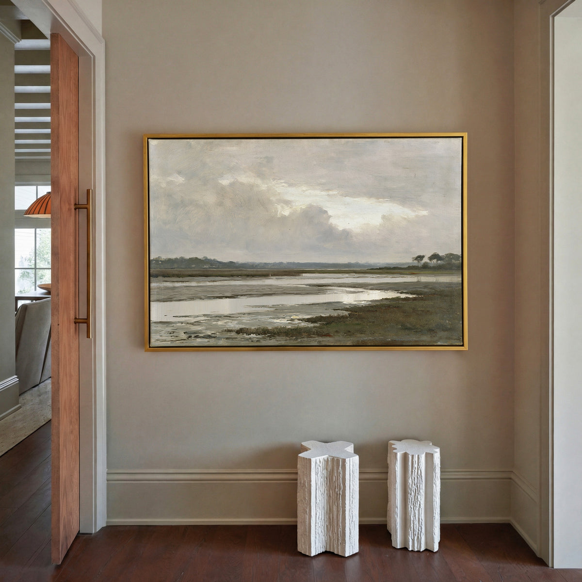 quiet inlet with mudflats and distant reed beds canvas wall art in a gold frame in a styled room setting