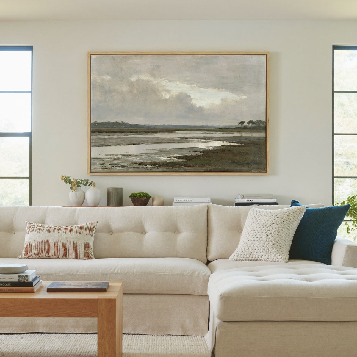 quiet inlet with mudflats and distant reed beds canvas wall art in a natural wood frame in a living room