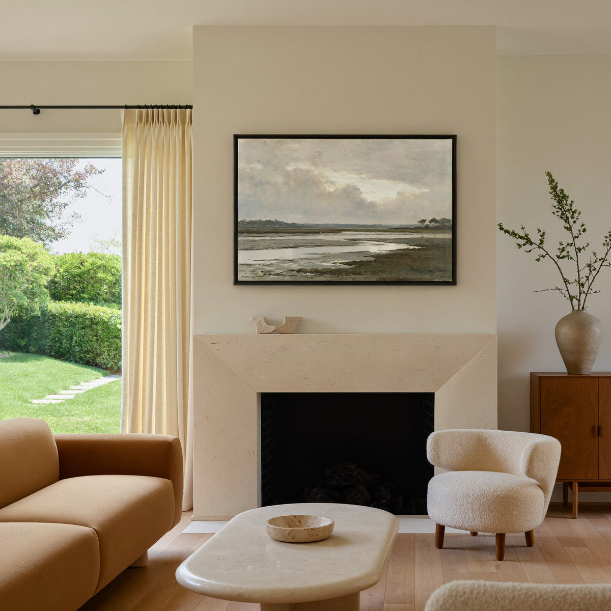 quiet inlet with mudflats and distant reed beds canvas wall art in a black frame above a mantel