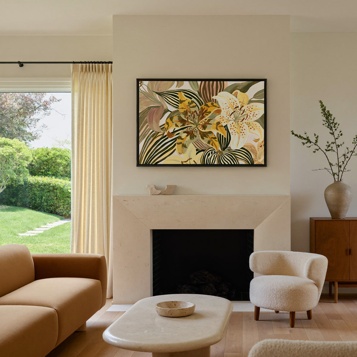 oversized yellow and cream tiger lilies among canvas wall art in a black floater frame above a mantel