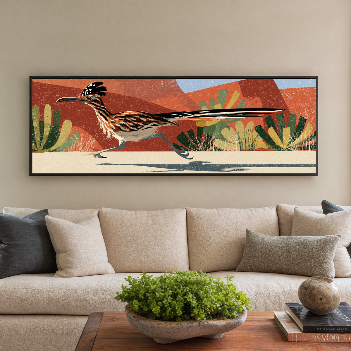 long tailed roadrunner crossing terracotta canvas wall art in a black floater frame in a styled room setting