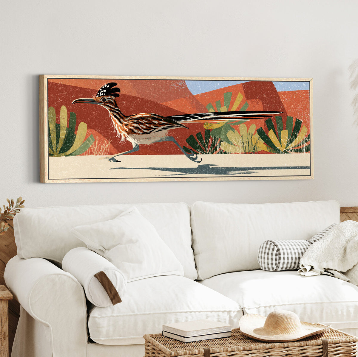 long tailed roadrunner crossing canvas wall art in an oak finish floater frame in a styled room setting