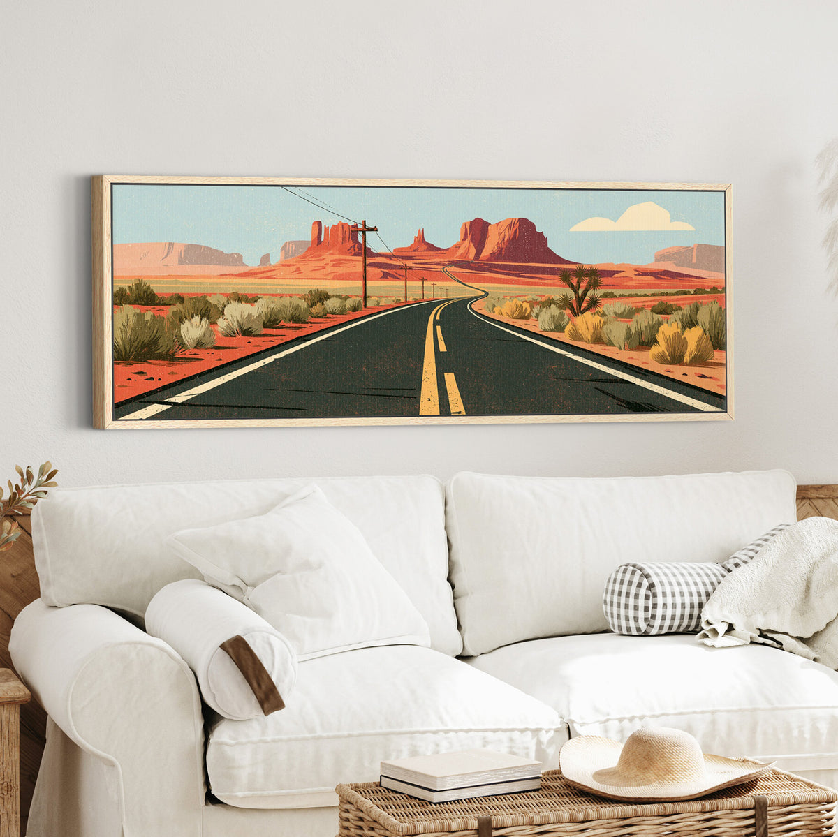 winding desert highway beneath canvas wall art in an oak finish floater frame in a styled room setting