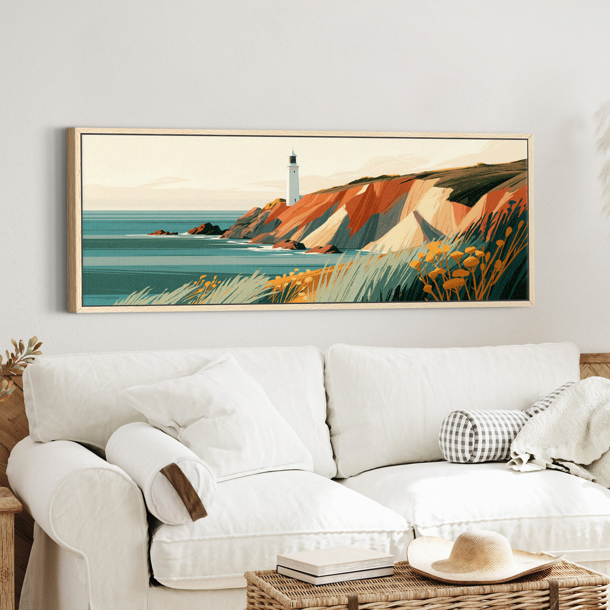 white lighthouse above rust canvas wall art in an oak finish floater frame in a styled room setting