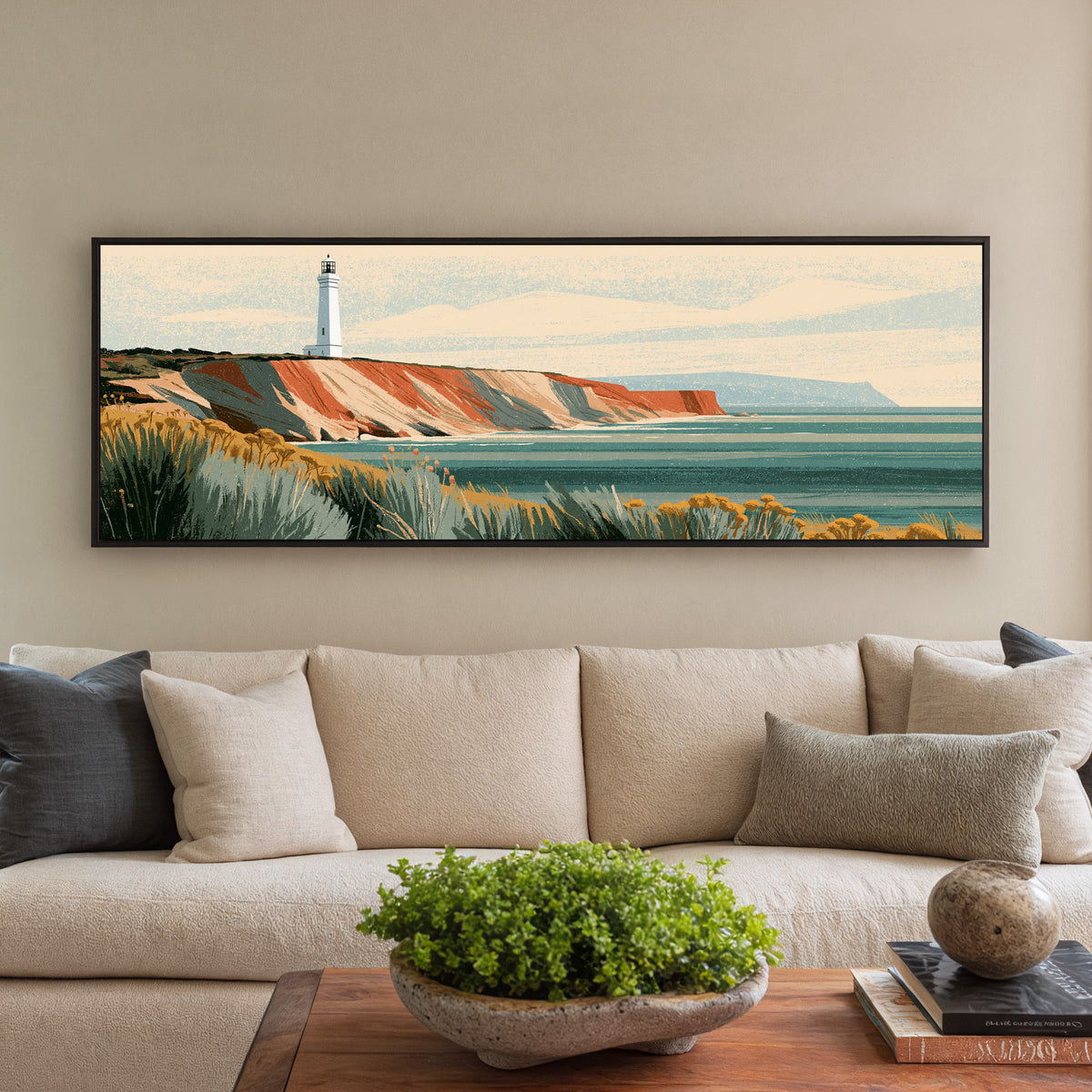 white lighthouse above terracotta canvas wall art in a black floater frame in a styled room setting