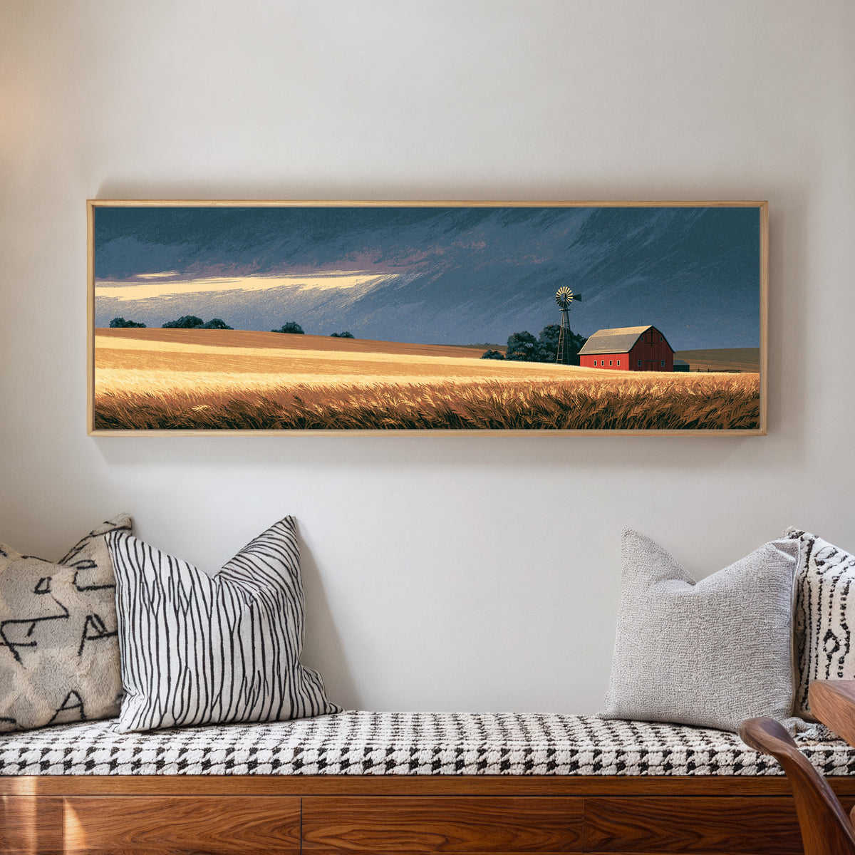 red barn and windmill across golden prairie canvas wall art in a natural floater frame in a living room