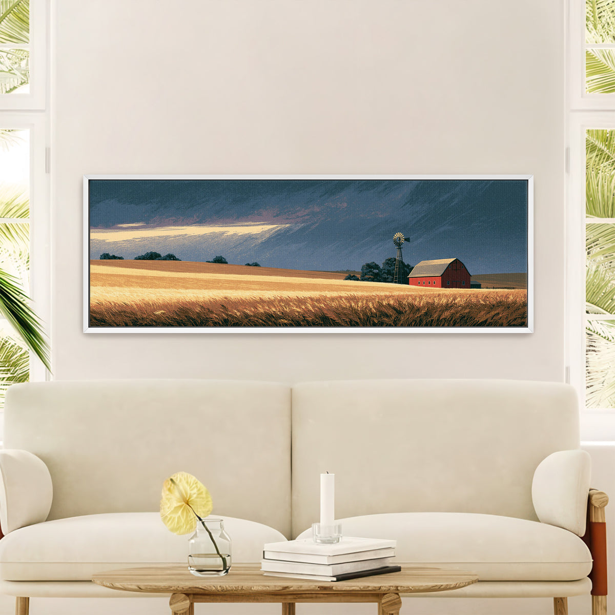 red barn and windmill across golden prairie canvas wall art in a white floater frame in a styled room setting