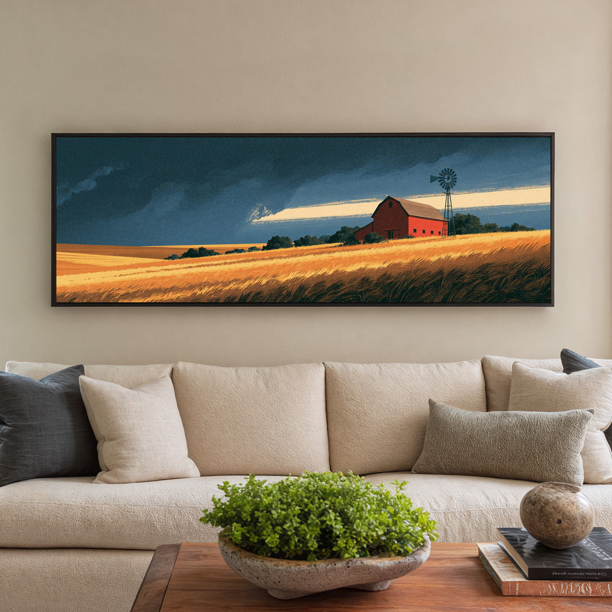 red barn and windmill above golden fields canvas wall art in a black floater frame in a styled room setting