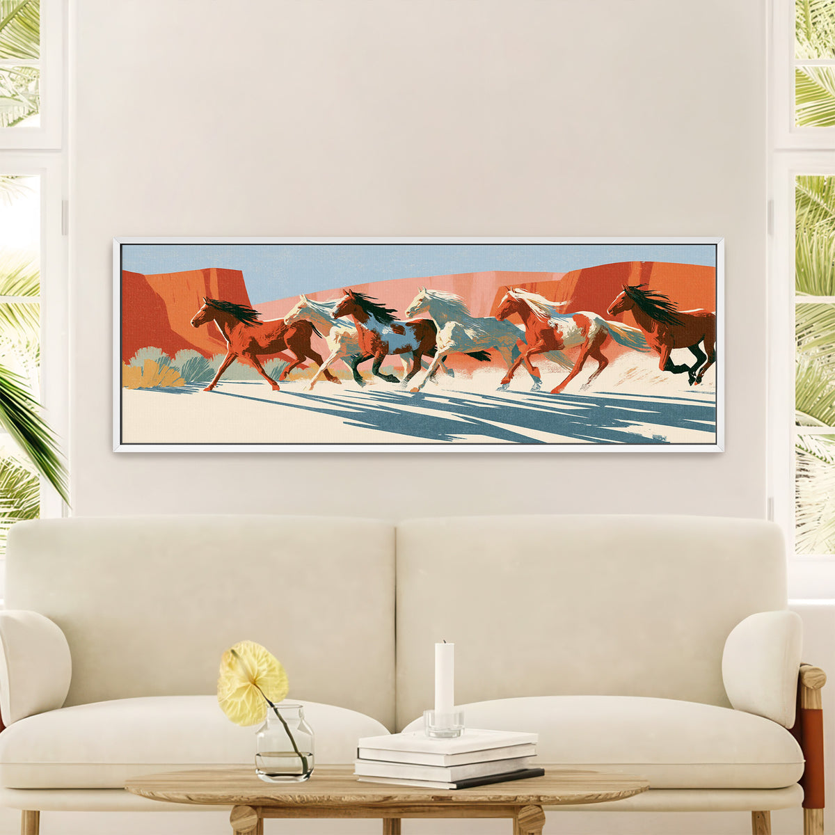 running horse herd beneath terracotta cliffs canvas wall art in a white floater frame in a styled room setting