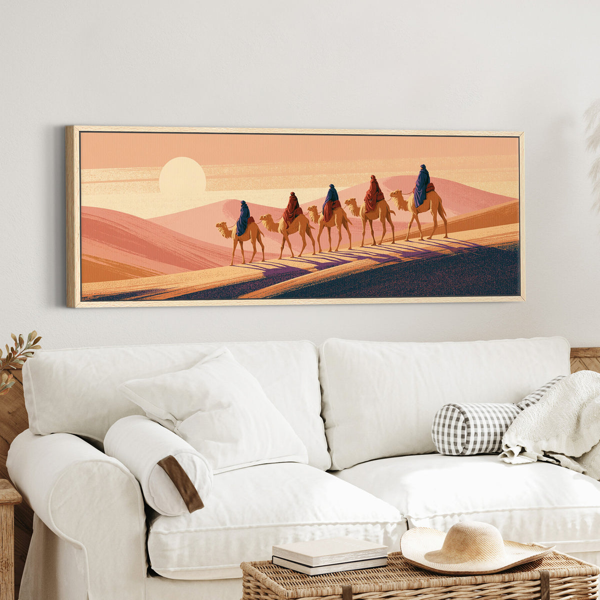 five camel riders crossing peach canvas wall art in an oak finish floater frame in a styled room setting