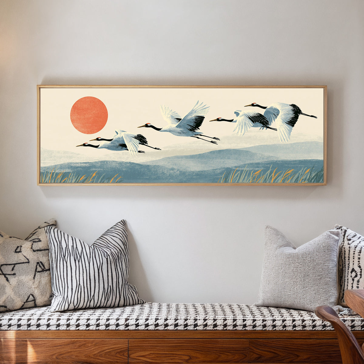 red crowned cranes flying over blue hills canvas wall art in a natural floater frame in a living room