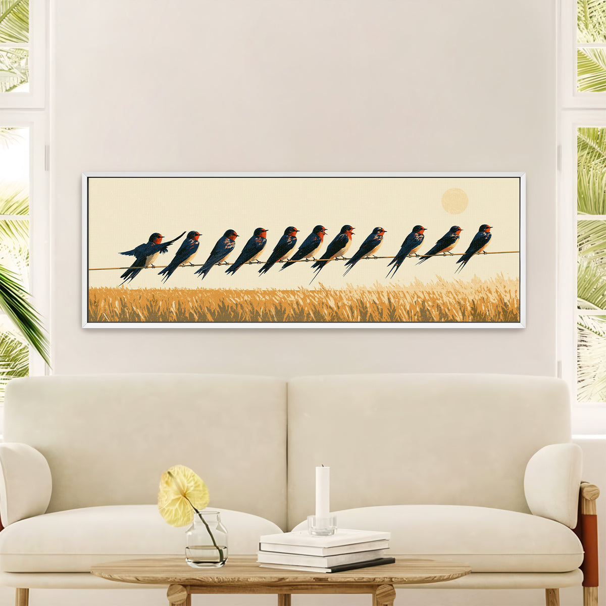 navy barn swallows perched above canvas wall art in a white floater frame in a styled room setting