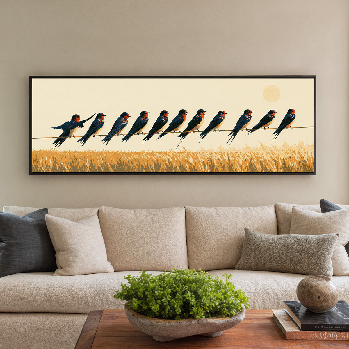navy barn swallows perched above canvas wall art in a black floater frame in a styled room setting