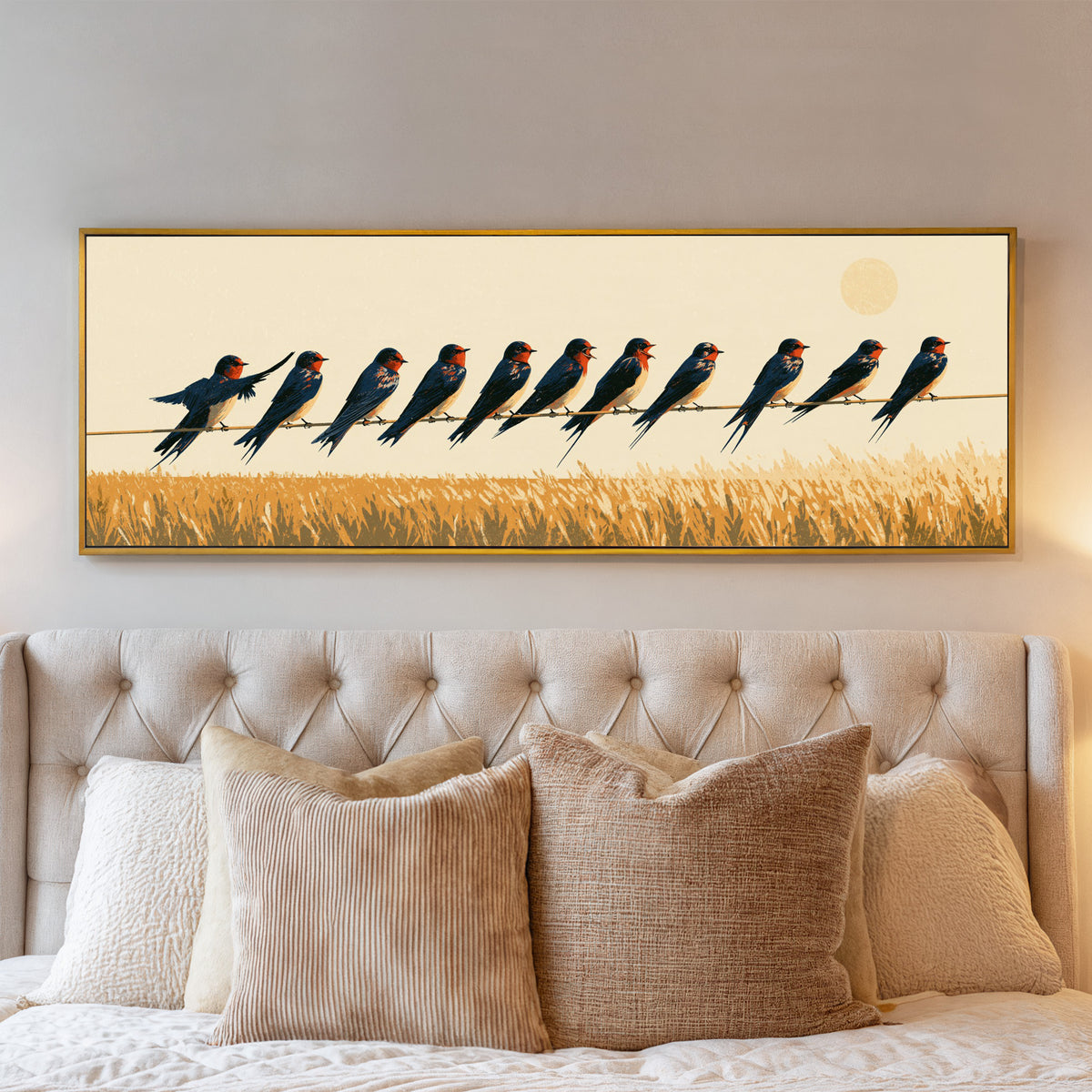 navy barn swallows perched above an ochre field canvas wall art in a gold floater frame above a bed