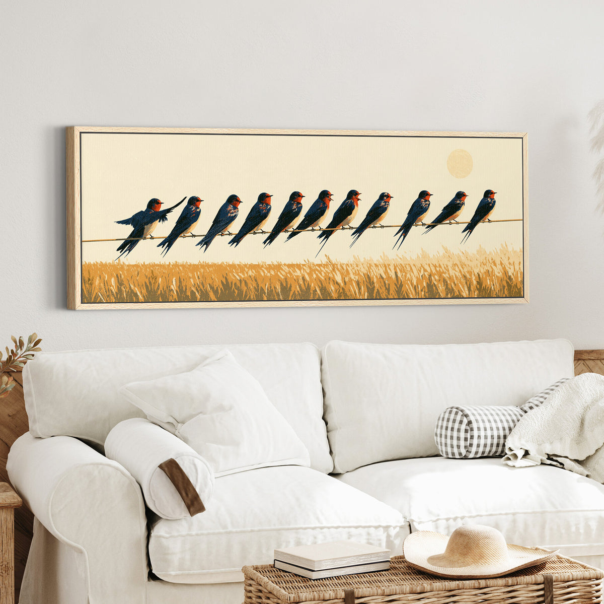 navy barn swallows perched above canvas wall art in an oak finish floater frame in a styled room setting