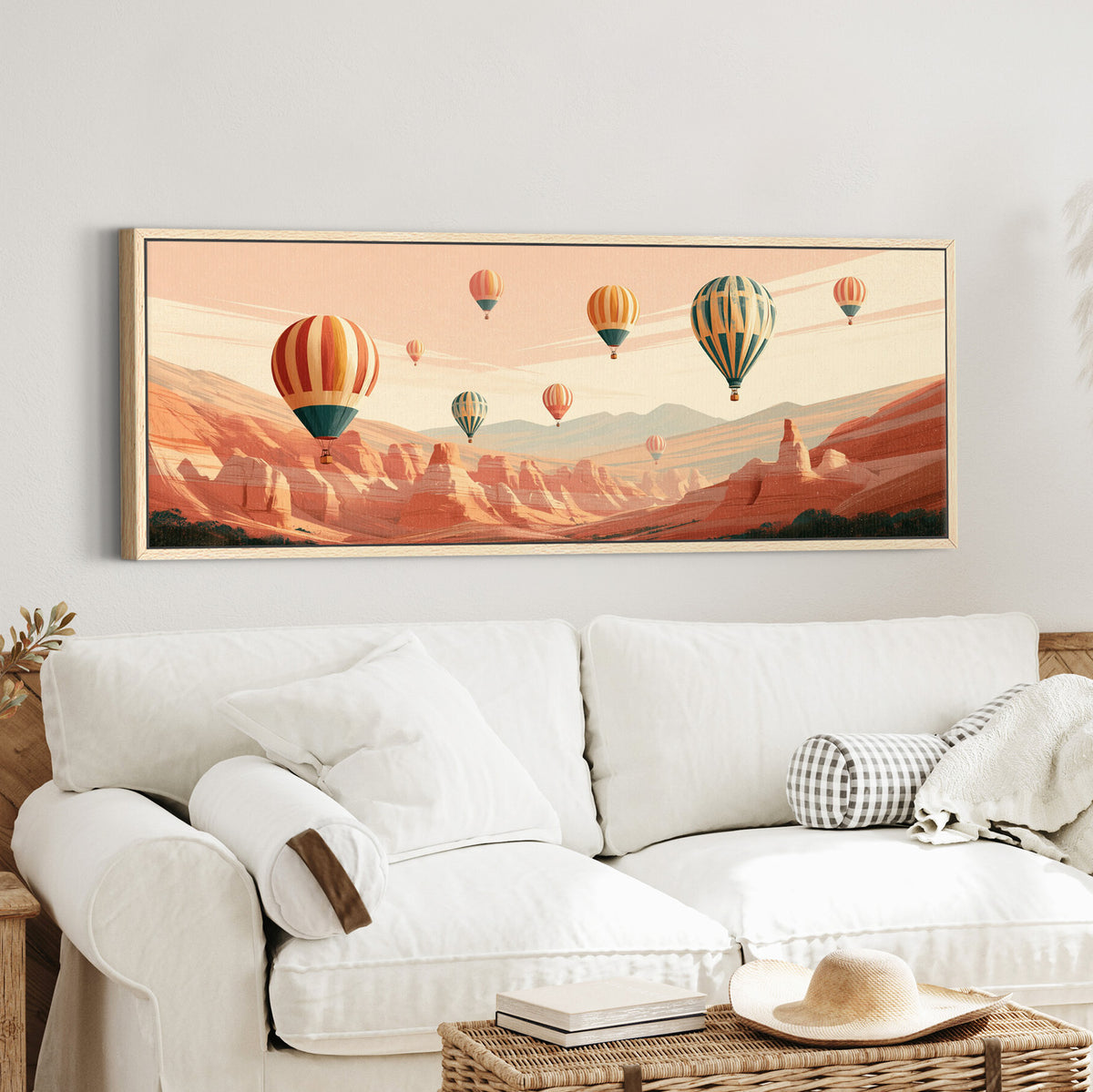 striped hot air balloons above a canvas wall art in an oak finish floater frame in a styled room setting