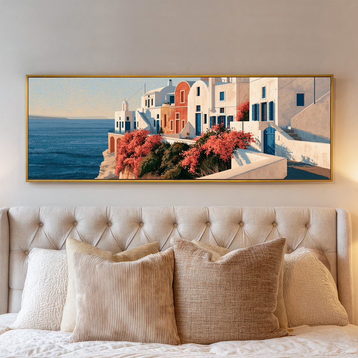 white seaside houses with blue shutters and canvas wall art in a gold floater frame above a bed