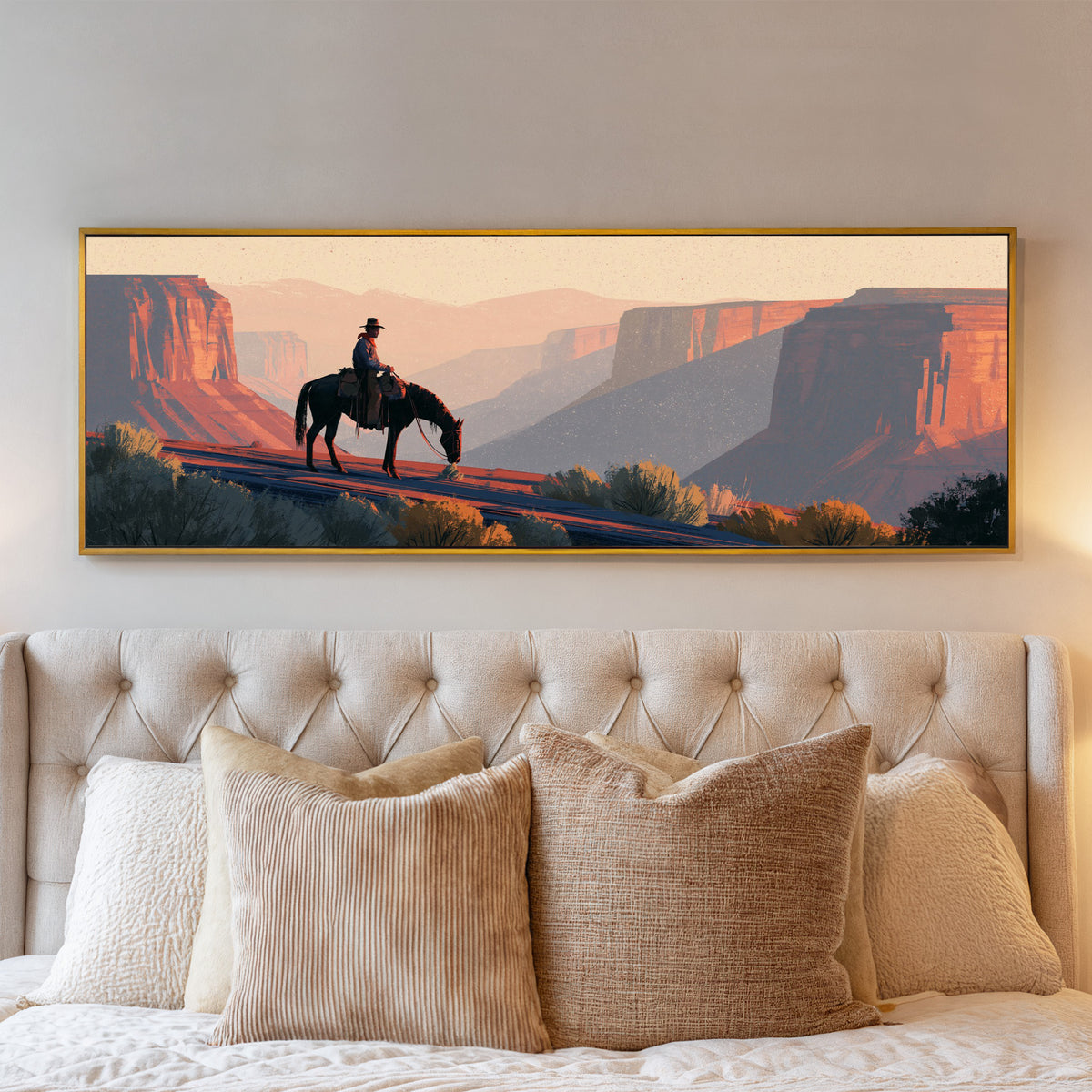lone mounted cowboy above terracotta canyon canvas wall art in a gold floater frame above a bed