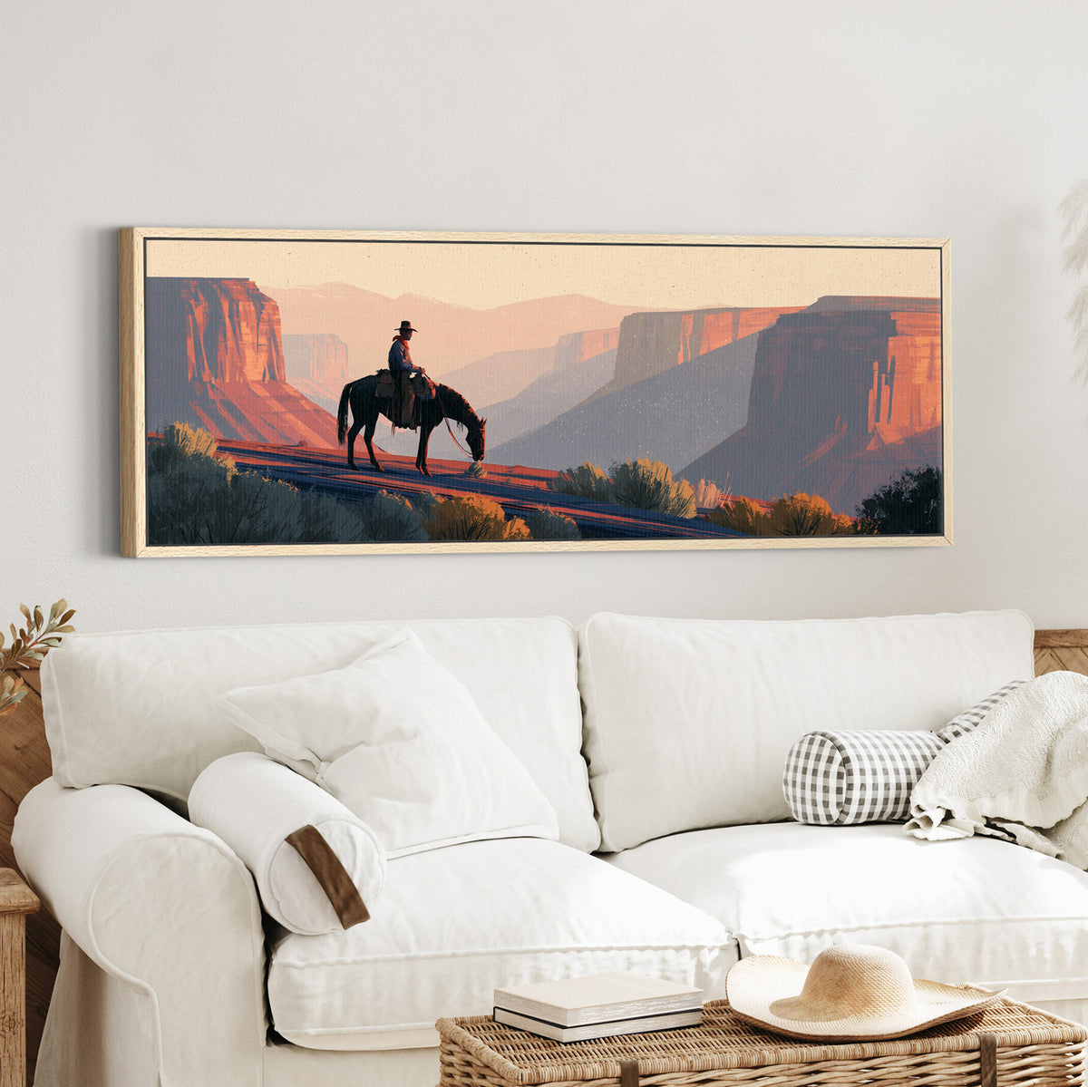 lone mounted cowboy above canvas wall art in an oak finish floater frame in a styled room setting